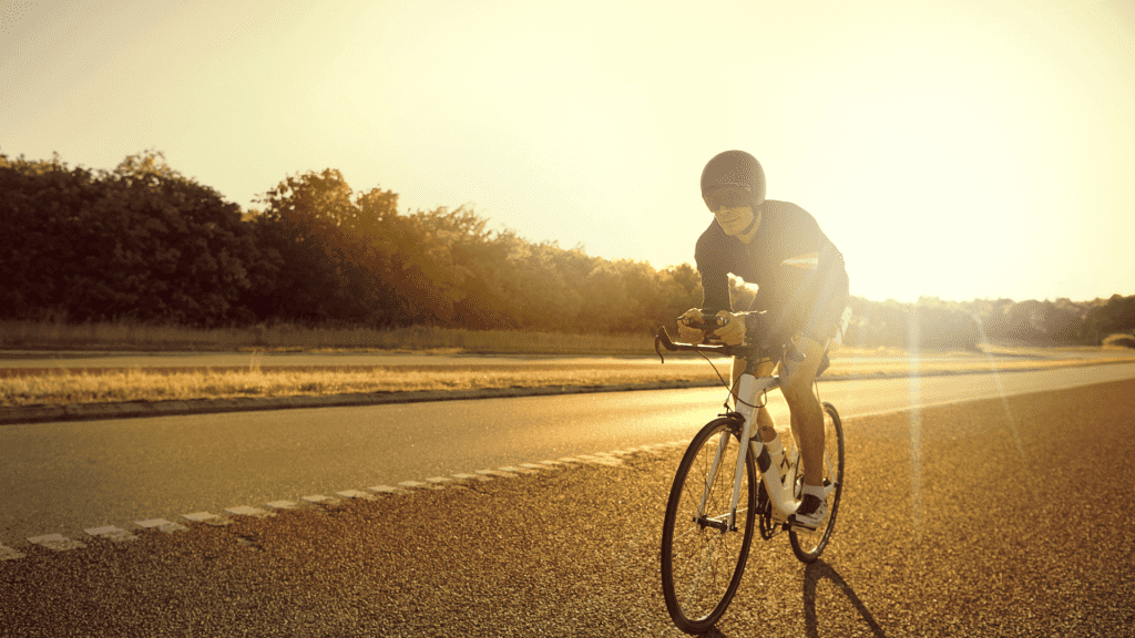 a man is biking on the road.